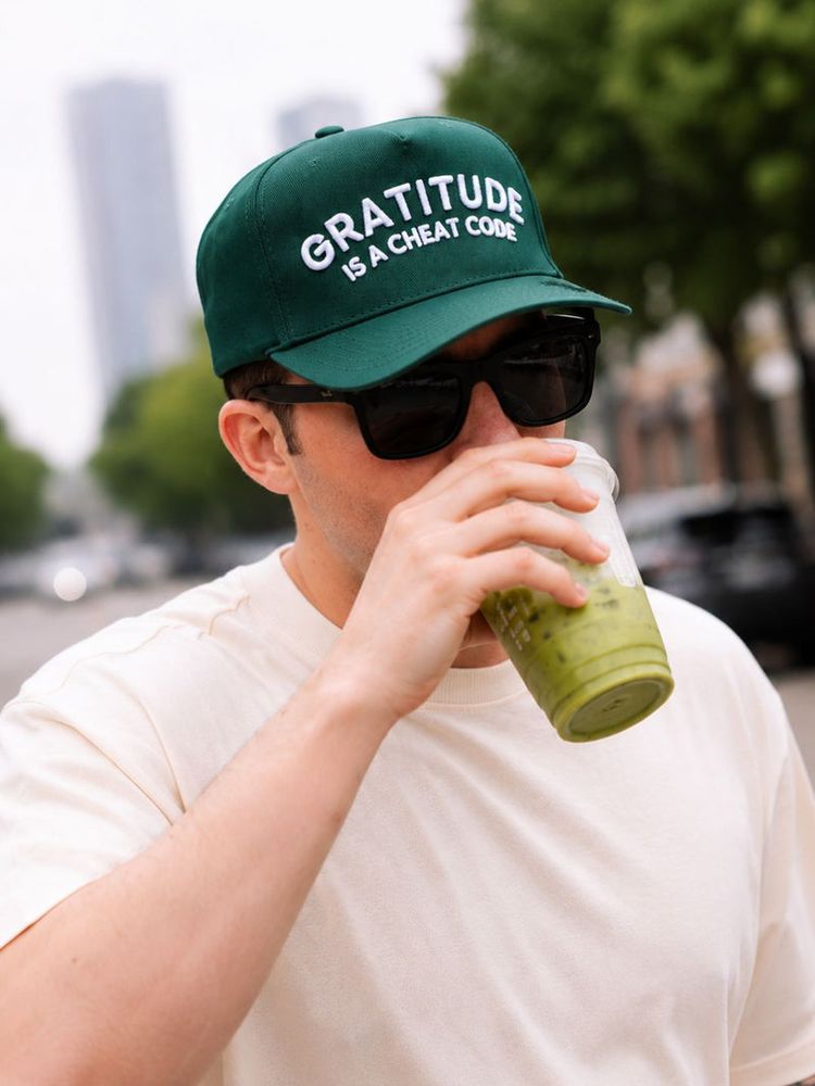 "Gratitude is a Cheat Code" on Green Cap